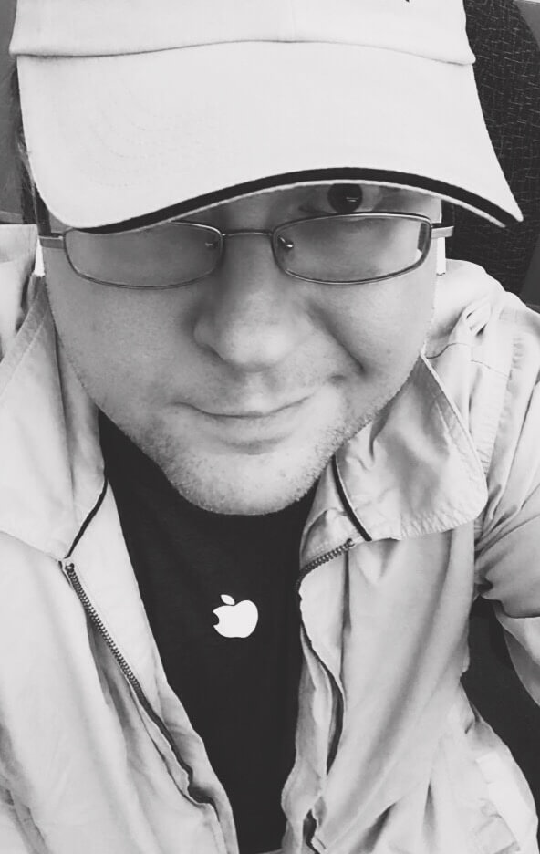 Black and white selfie of a dude in a cap